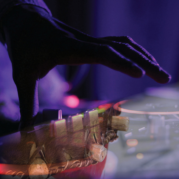 Close-up of a hand on a soundboard. 