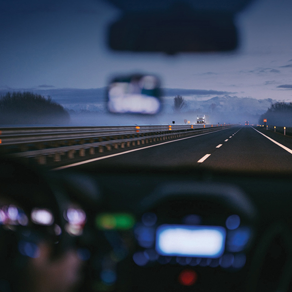 Photo of a road from the passenger seat of a car. 
