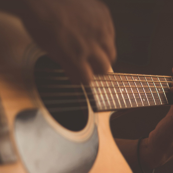 Close-up of hands playing the guitar. 
